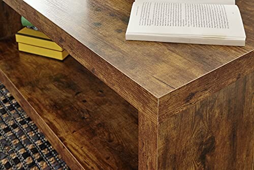 Wooden table with an open book and shelf below